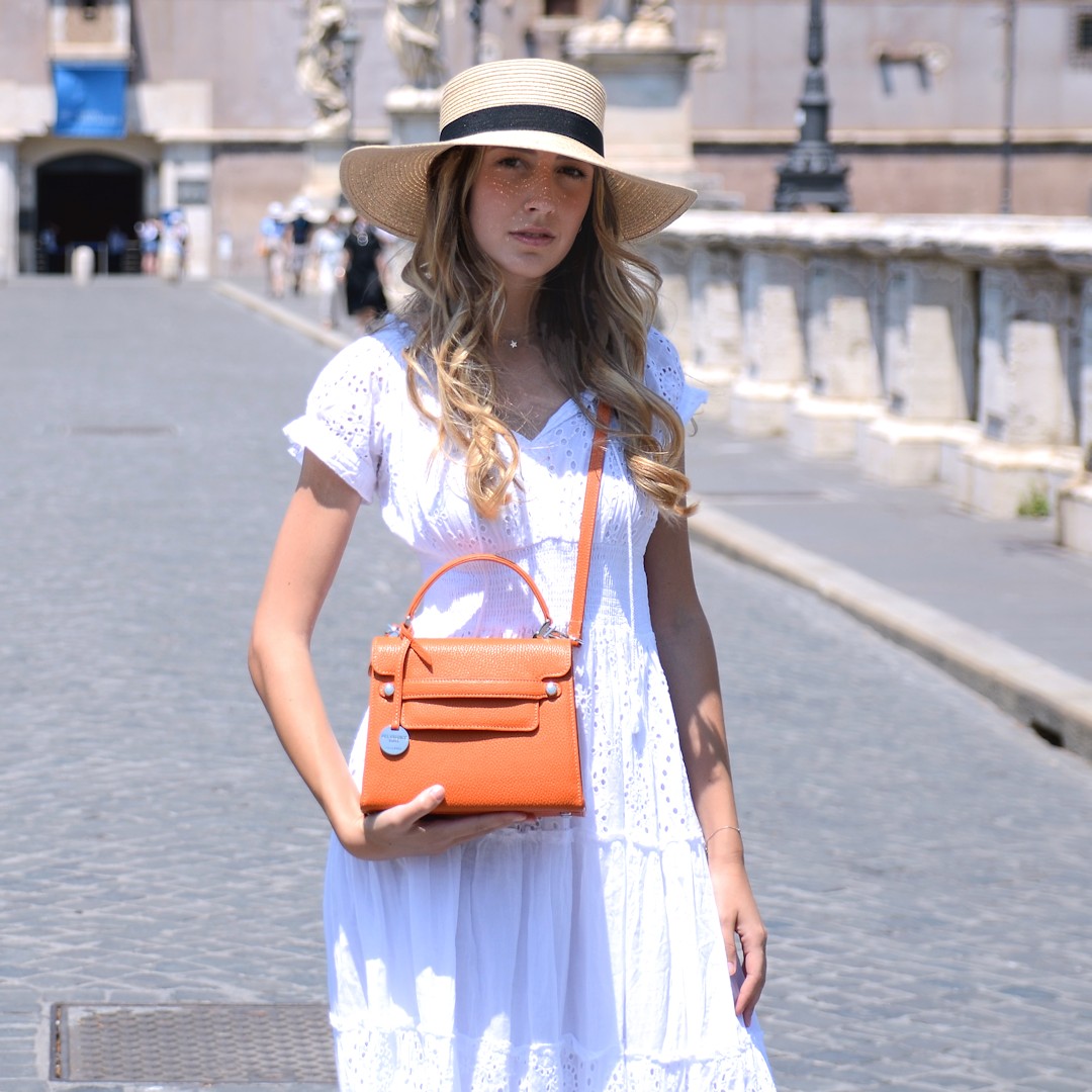 Italian leather handbag with strap Amelia S in orange color, worn by model
