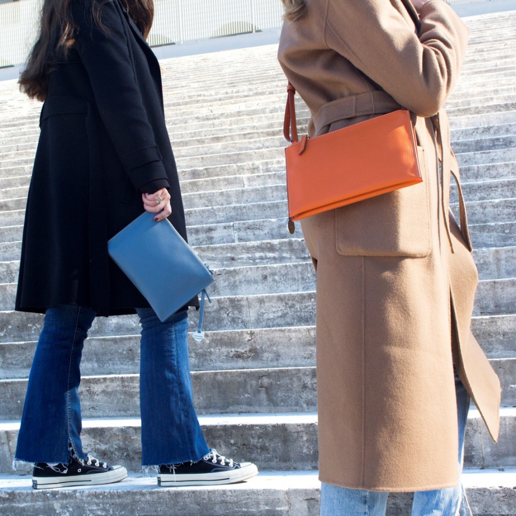 Double Zipper Crossbody Bag Susan in Fairy and Orange worn by Women on stairs of Square Colosseum (EUR)