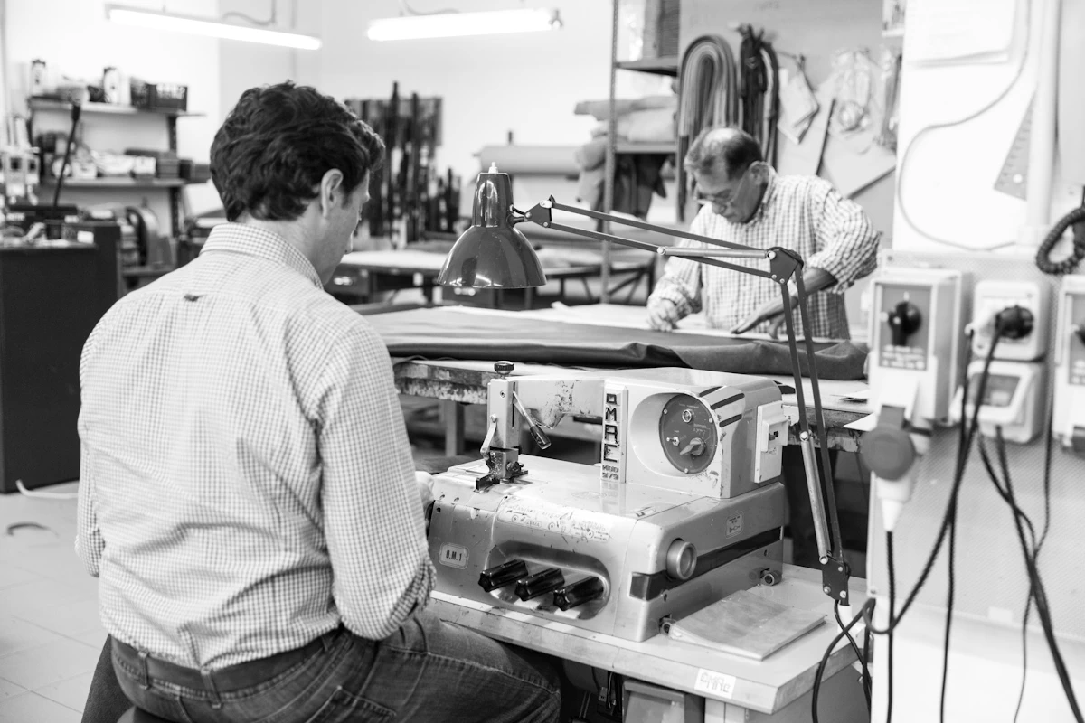 Skilled craftsmen creating artisanal leather bags at our Del Giudice's leather artisan workshop in Rome