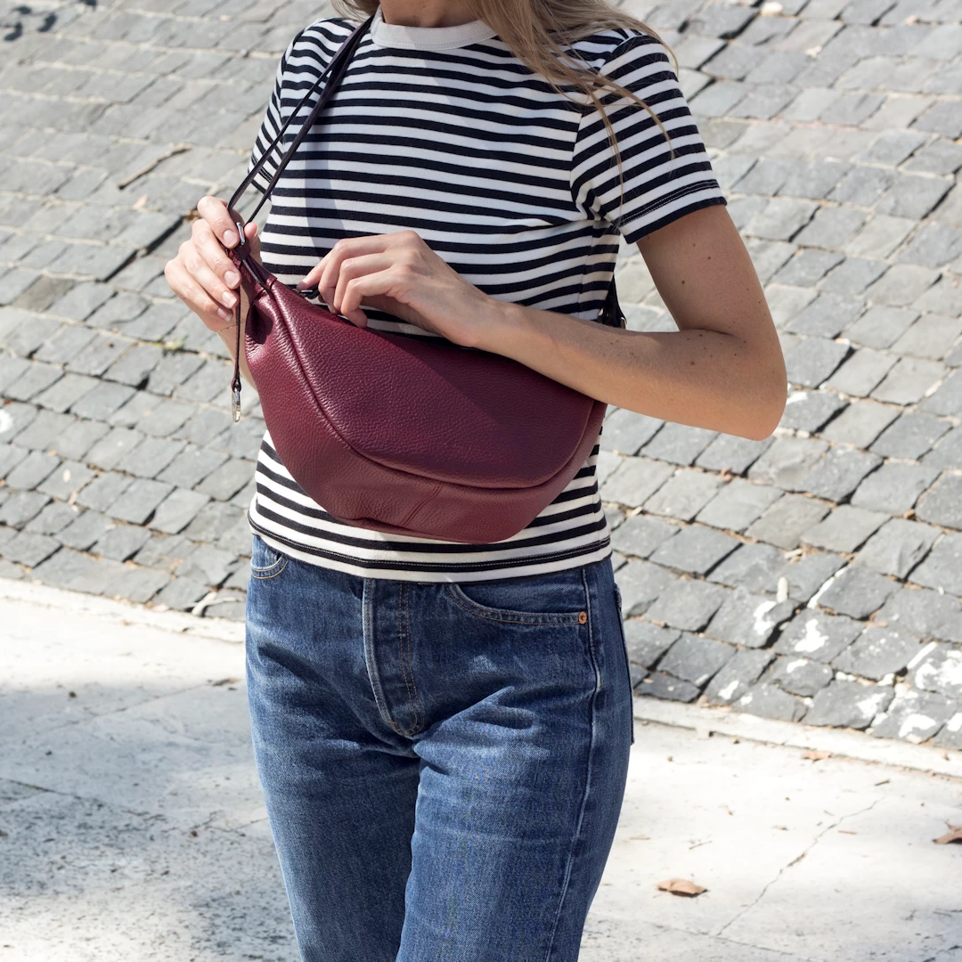 leather moon bag worn crossbody