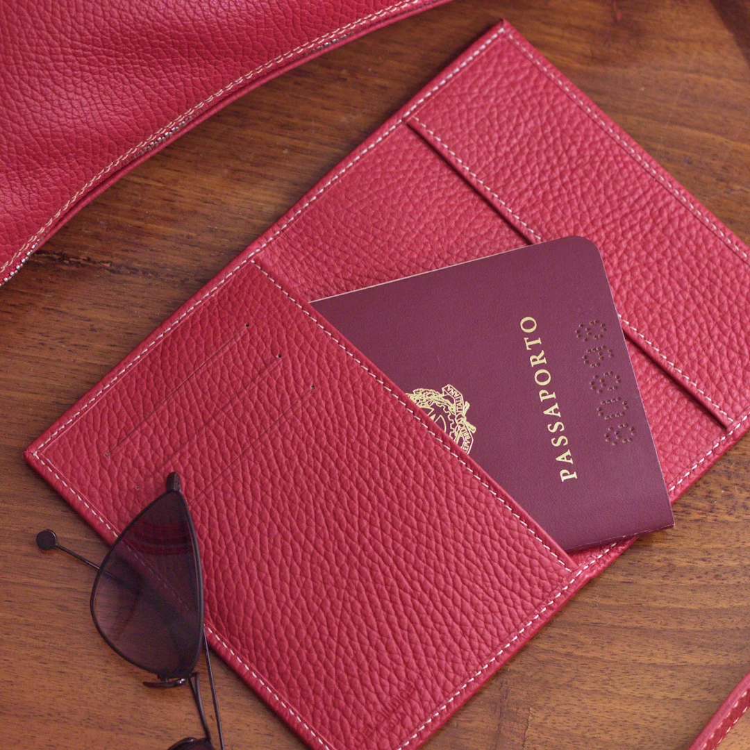 red leather passport holder with passport